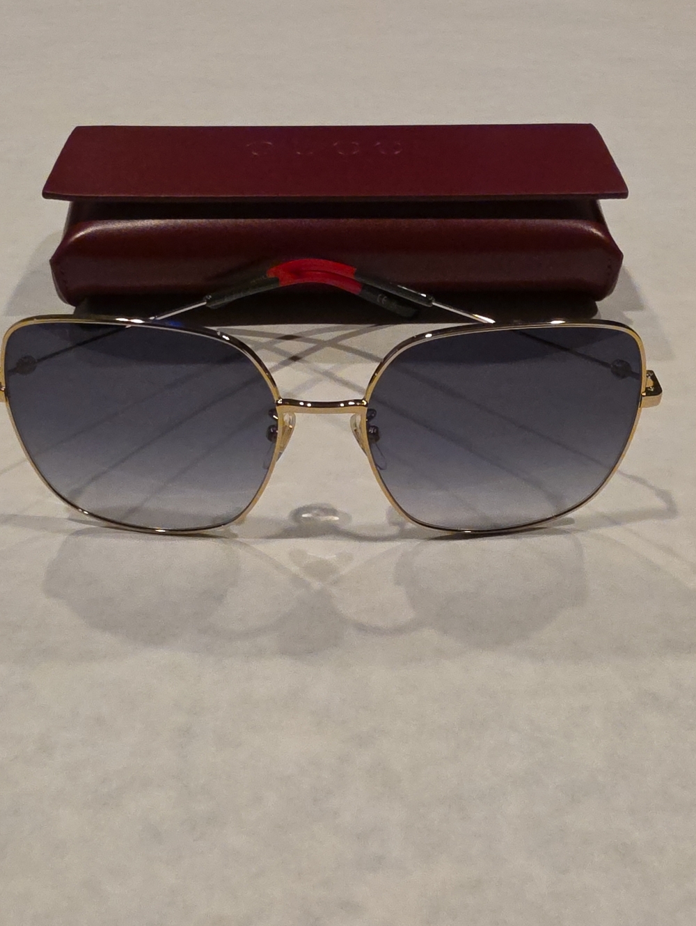 Gucci Gold Frame Sunglasses with Gradient Blue-Gray Lenses